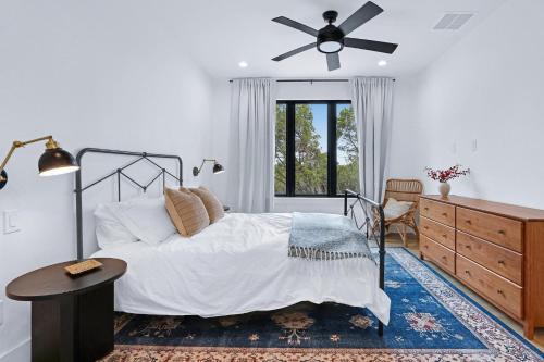 una camera da letto con un letto e un ventilatore a soffitto di Pasatiempos a Wimberley