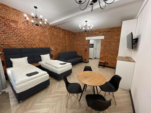 a living room with a couch and a table at Pod Błękitnymi Podkowami in Wrocław