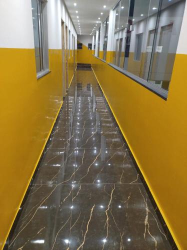 an empty hallway in a building with yellow and yellow walls at Hotel Boneario in Vitória da Conquista