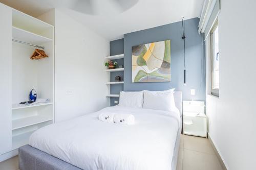 a white bedroom with a large white bed in it at Wonderful Loft in Casco Viejo in Panama City