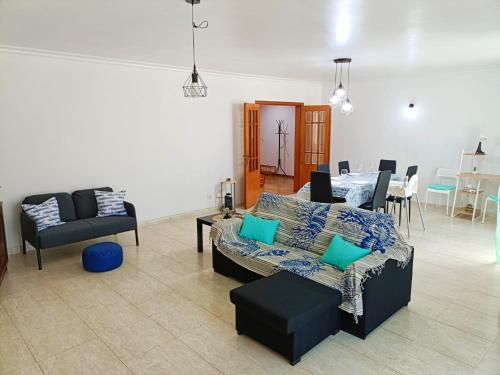 a living room with a couch and a table at Casa Besugo in Sesimbra