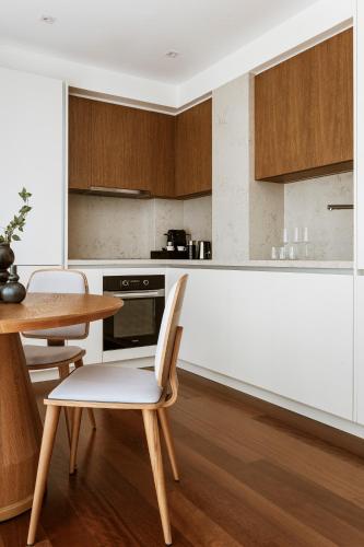a kitchen with a table and a table and chairs at Likno Athens in Athens