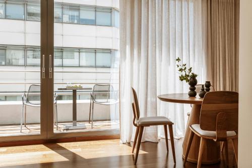 a living room with a table and a window at Likno Athens in Athens