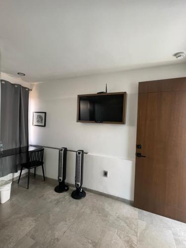 a room with two speakers and a flat screen tv on the wall at La Casa Mia Leon in León