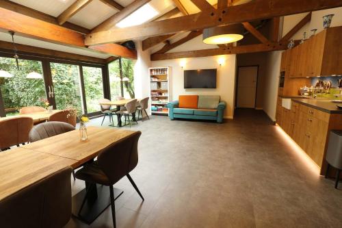 a large living room with a table and a couch at B&B Eemswolde in Delft