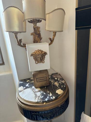 a toilet with two lamps and a box on it at Le Stanze del Principe in Genova