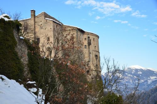 an old castle on the side of a mountain at Bfour in Pergine Valsugana
