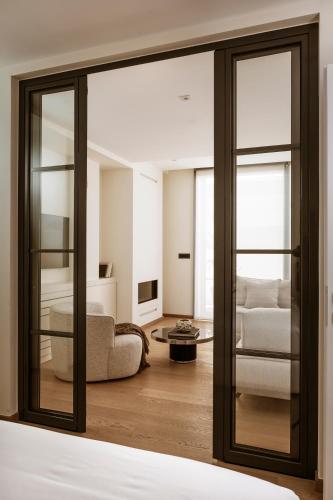 a living room with a sliding glass door at Likno Athens in Athens