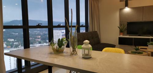 a table in a living room with a window at M City Ampang KLCC Lake view Pool in Kuala Lumpur