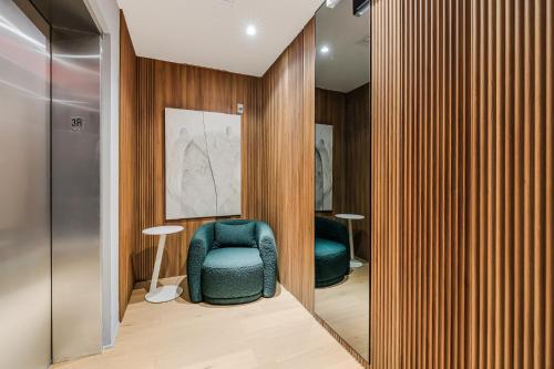 a room with a blue chair and wooden walls at The March Hotel in Miami Beach