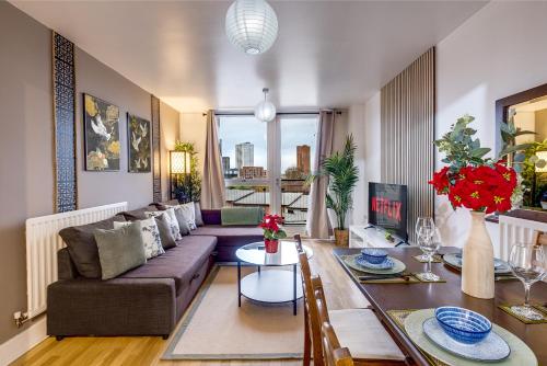 a living room with a couch and a table at Asian Suite- Balcony - Nexflix and FREEPark in Birmingham