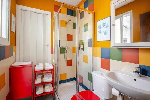 a colorful bathroom with a sink and a toilet at Ático la Azotea con terraza PRIVADA in Seville