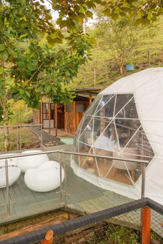 a dome tent with two toilets in a garden at Riverside La Masía Ecohotel in Quindío