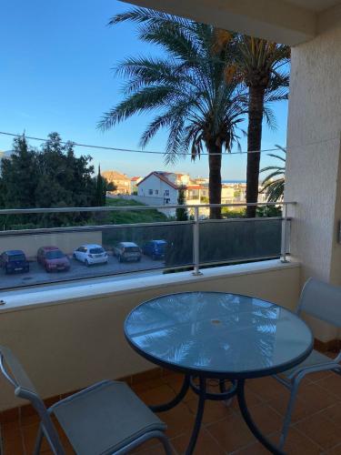 a table and chairs on a balcony with a view of a street at Playa y paz in Benalmádena
