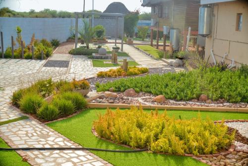 a garden with flowers and plants in a yard at Kebo events agro &self catering apartments in Mochudi