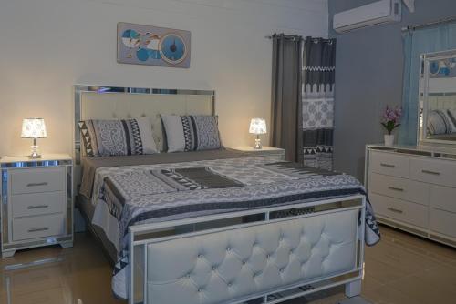 a bedroom with a large bed and a dresser at Casa Ballenas3 SF in Las Terrenas