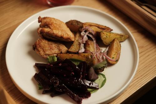 a plate of food with chicken and vegetables on a table at Robert Hotel in Dragobrat