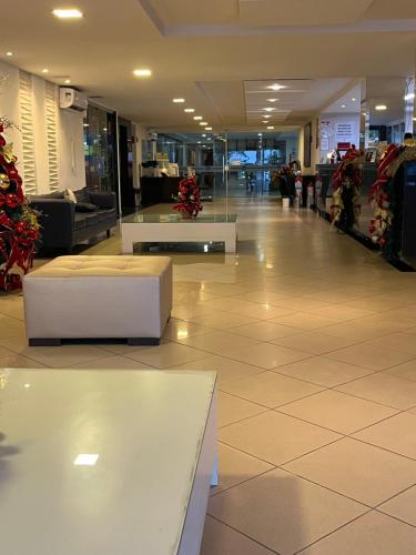 a lobby with couches and tables in a building at Imperial flat tambau Joao Pessoa in João Pessoa