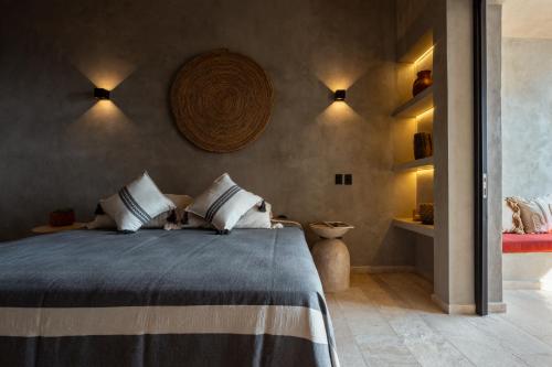 a bedroom with a large bed with two pillows at La Olita in Puerto Escondido