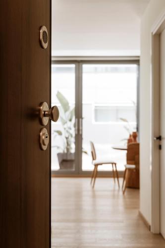 an open door to a living room with a table at Likno Athens in Athens