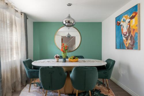 a dining room with a table with chairs and a mirror at High Life Stays in Broughton