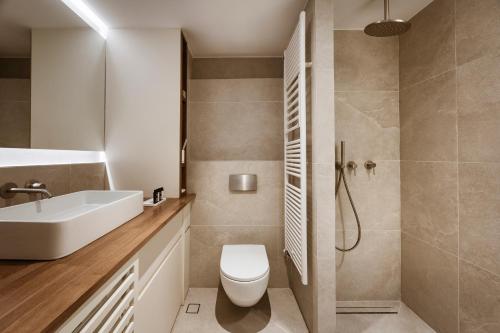 a bathroom with a toilet and a sink and a shower at Likno Athens in Athens