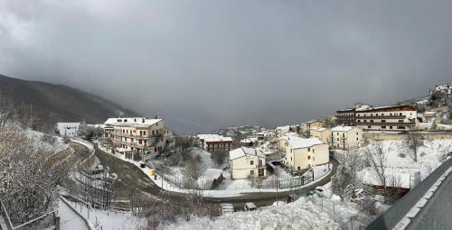 a town covered in snow on a mountain at Casa Vacanze Campo Felice in Casamaina