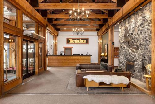 a living room with a couch and a fireplace at Tantalus Lodge by Elevate Vacations in Whistler