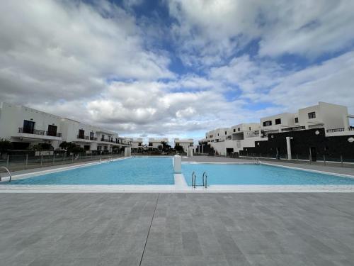 a large swimming pool in the middle of a building at Beach Dúplex Costa Teguise in Costa Teguise