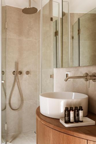 a bathroom with a sink and a shower at Likno Athens in Athens