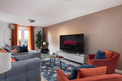 a living room with two couches and a flat screen tv at High Life Stays in Broughton