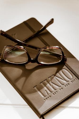 a pair of glasses sitting on top of a cell phone at Likno Athens in Athens