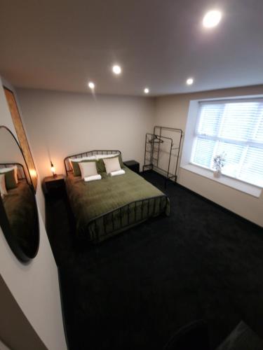 a bedroom with a bed and a window at New Stylish 4-Bed-WiFi-Free Parking in Leamington Spa