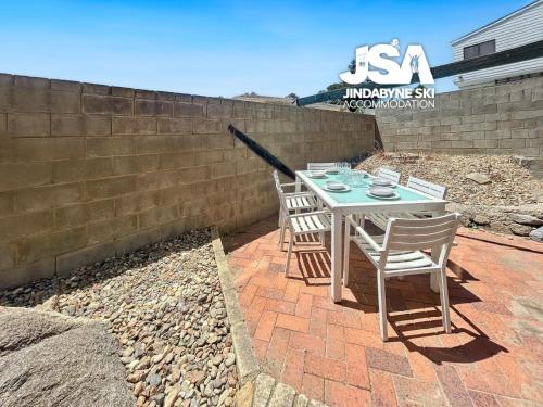 a table and chairs sitting on a brick patio at Central Park 2 in Jindabyne
