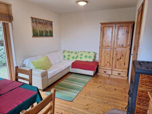a living room with a couch and a table at Pohorje Zen Garden in Pohorje