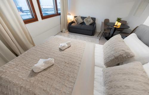 a living room with a bed and a couch at Ainonkatu Central Studio in Rovaniemi