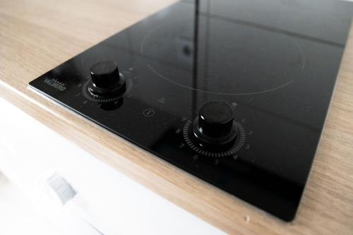a microwave oven with two black knobs on it at T2 cosy et moderne proche Confluence in Oullins
