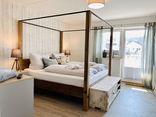 a bedroom with a canopy bed in a room at Ferienwohnung Weltenbummler Haus Strandbummler Baabe in Baabe