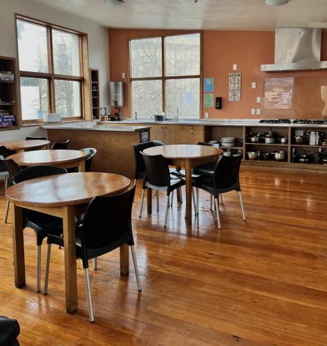 a restaurant with tables and chairs in a room at On Top Backpackers in Dunedin
