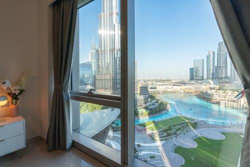 a room with a large window with a view of a city at Unmatched Burj Khalifa & Fountain Show View-Amazing For New Years-1701 in Dubai