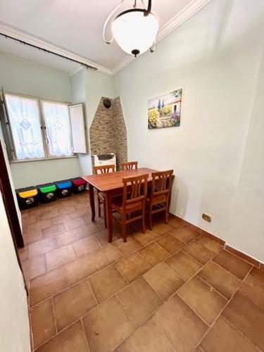 a dining room with a wooden table and chairs at Mussomeli Palazzo in Mussomeli
