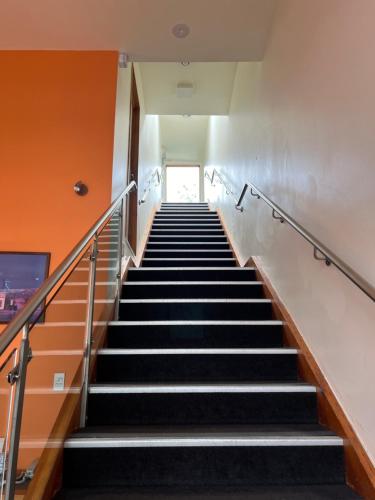 a staircase in an office building with escalators at On Top Backpackers in Dunedin