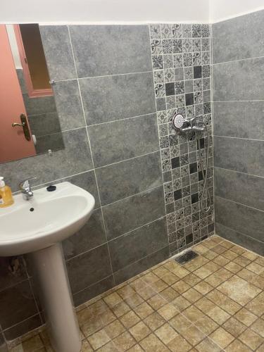 a bathroom with a sink and a shower at Dar MIMA in Rabat