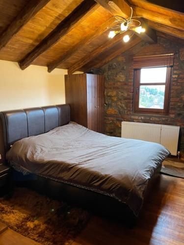 a bed in a room with a ceiling fan at MHome AGIOS ATHANASIOS in Palaios Agios Athanasios