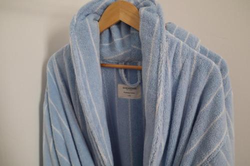 a blue robe is hanging on a hanger at Villa Baci Bendigo in Bendigo
