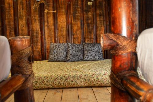 a bed with two pillows on it in a room at Cabañas Rusticas El Viejo Tambo in San Pedro