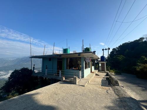 a small building on the side of a mountain at Junekeri Hides in Māngwa