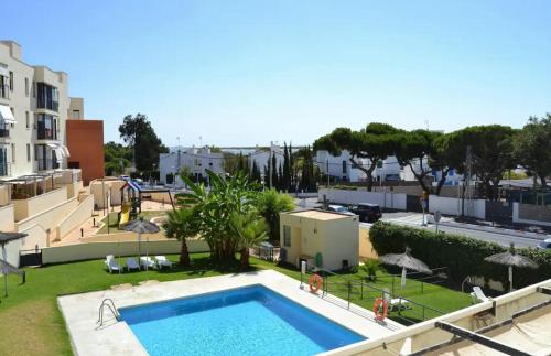 a view of a swimming pool in a resort at Apartamento Vacacional El Rompido in El Rompido