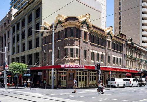 a large building on the corner of a city street at The Resch House in Sydney