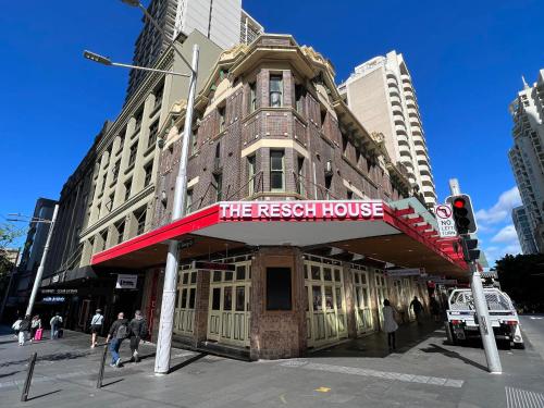 a building with a red sign on the front of it at The Resch House in Sydney